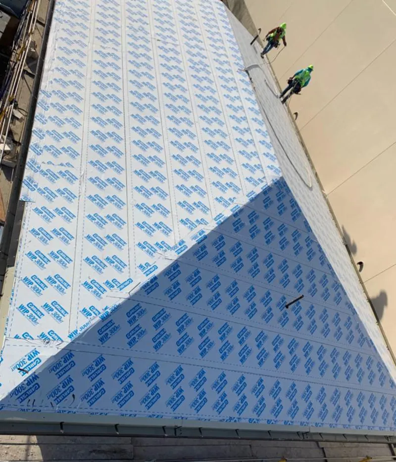 Professional roofers installing underlayment on a metal roof in Hillcrest Heights